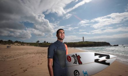 surfer holds a surfboard