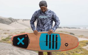 man holds a surfboard