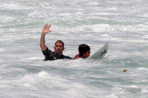 instructor teaches on a surfboard