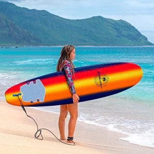 girl surfer stands with a surfboard