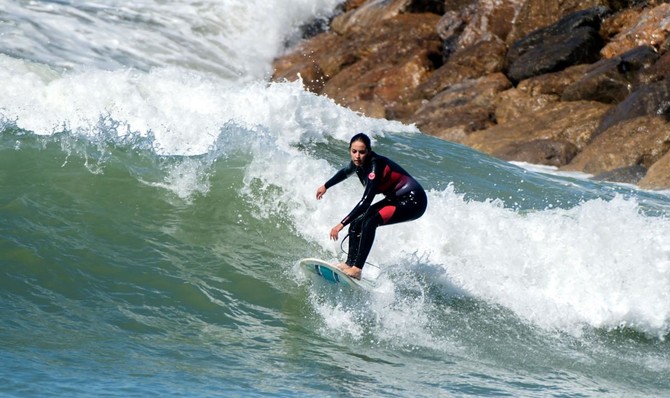 women surfers ride out waves